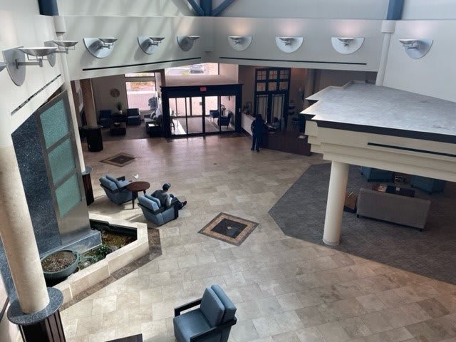 A spacious lobby with seating areas and a modern design.