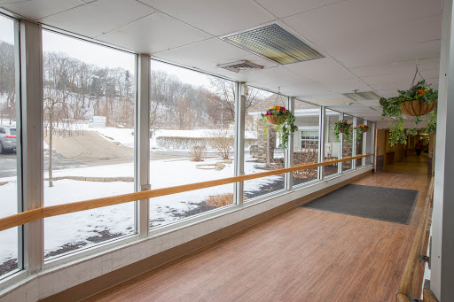 A bright corridor with large windows showcasing a snowy landscape outside.