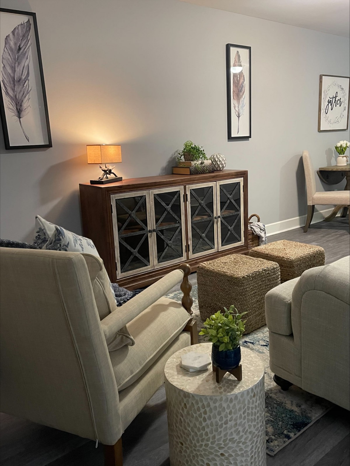 A cozy living room with modern decor, featuring comfortable seating and indoor plants.