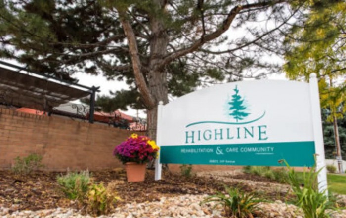 An outdoor sign for Highline Medical & Wellness Center surrounded by trees and landscaped flowers.