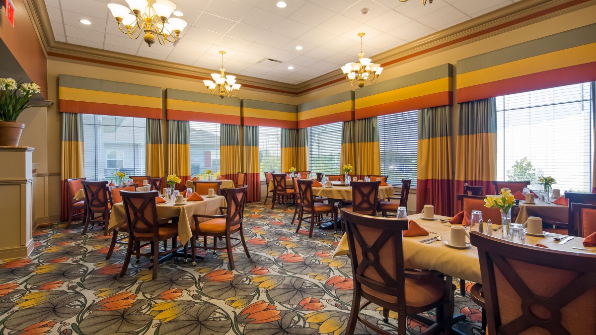 An elegantly decorated dining room with colorful curtains and chandeliers.