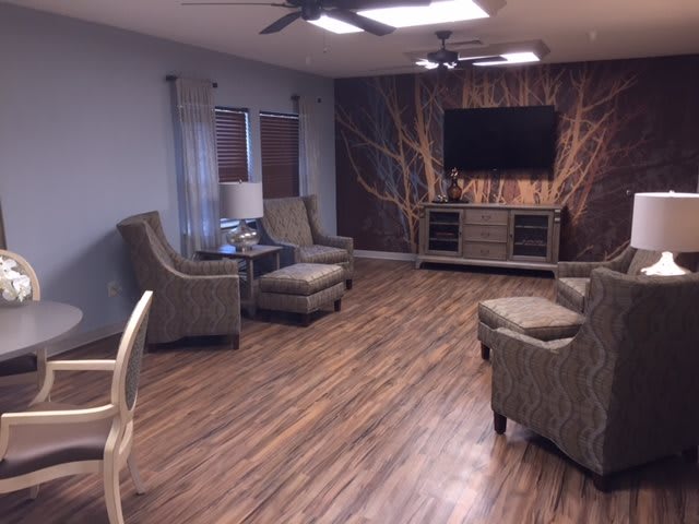 A modern living room with comfortable seating and a large television.