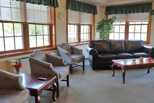 A cozy living room featuring comfortable seating and ample natural light.