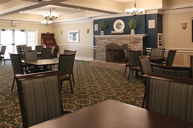 A cozy dining room with a fireplace and elegant furniture.