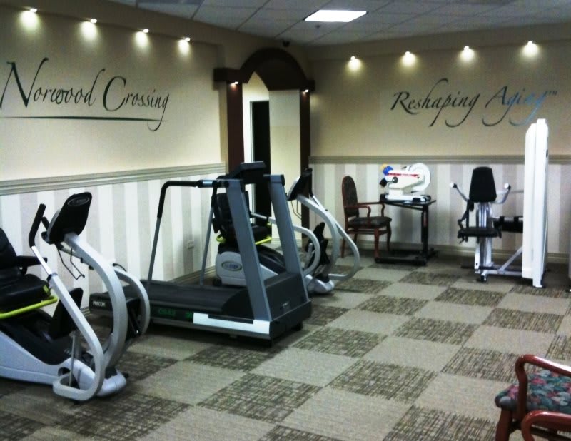 A well-equipped gym with various exercise machines and a welcoming atmosphere.