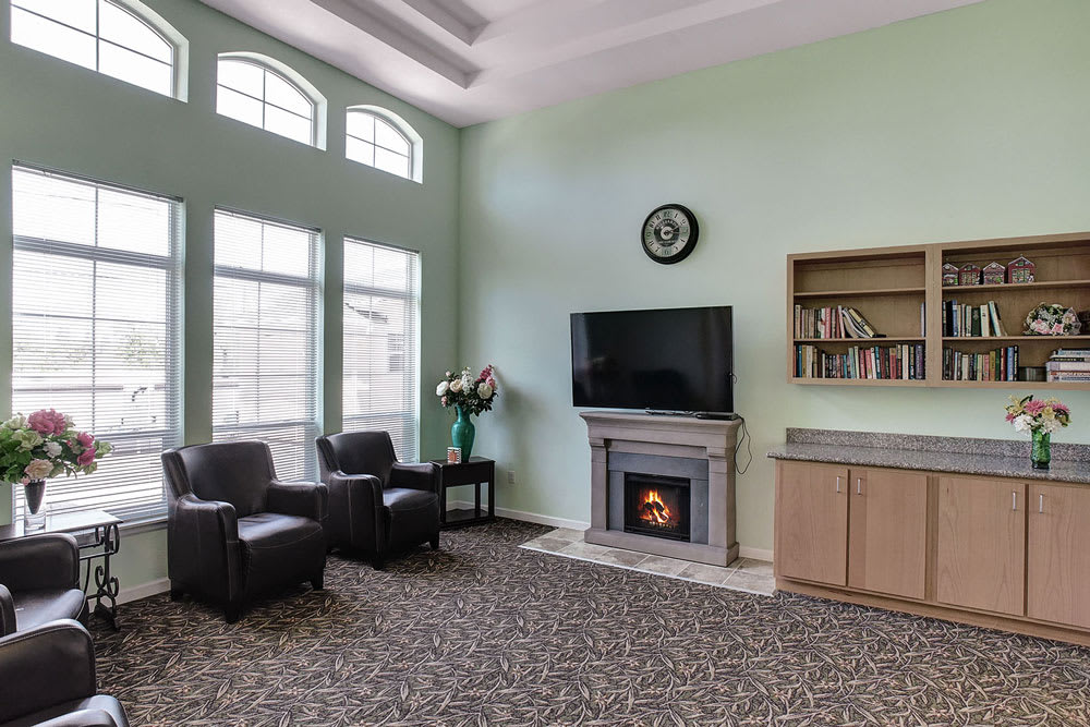 A cozy living room with a fireplace, television, and seating area.
