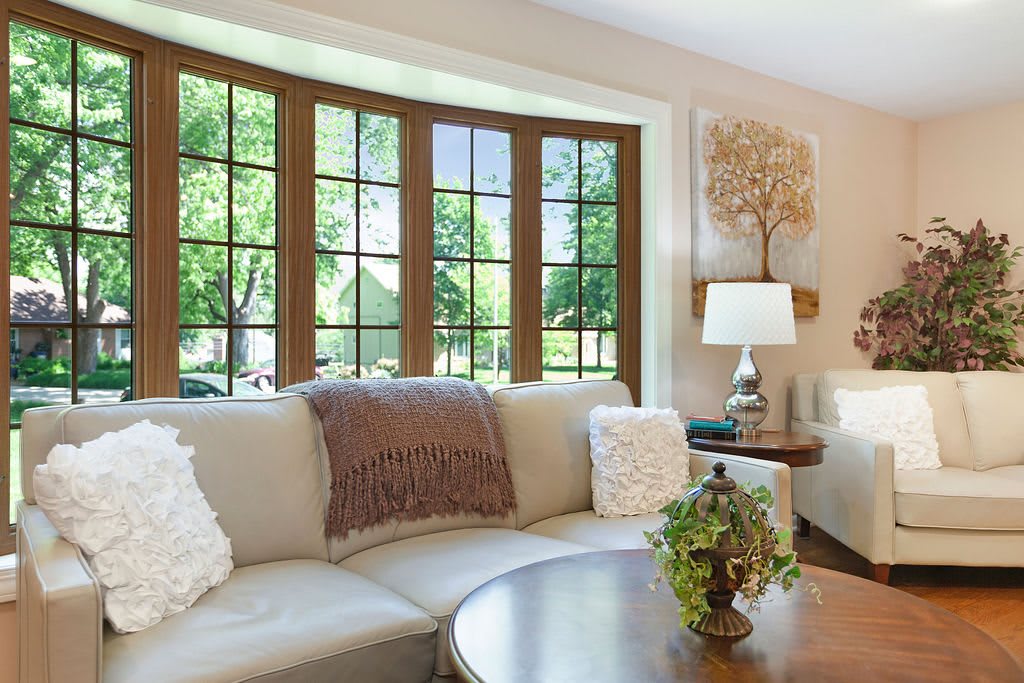 A cozy living room with a large window, comfortable couch, and stylish decor.