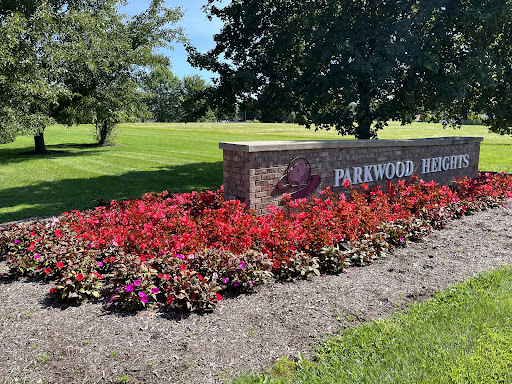 A beautiful park entrance surrounded by vibrant flowers.