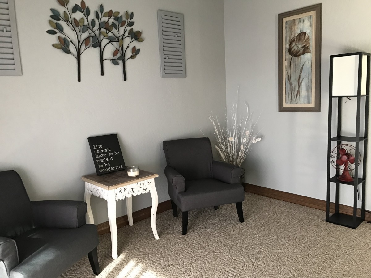A cozy waiting room with comfortable seating and decorative accents.