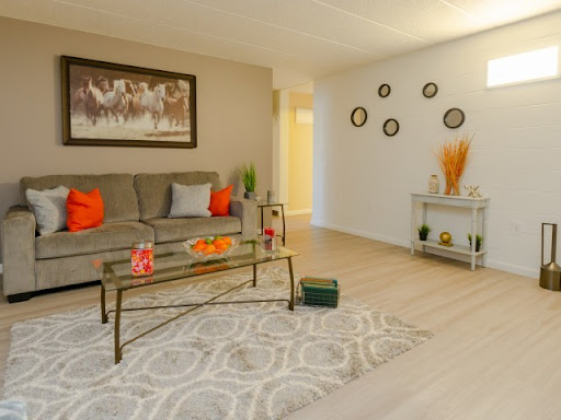 A beautifully designed living room featuring modern furniture, warm accents, and stylish decor elements.