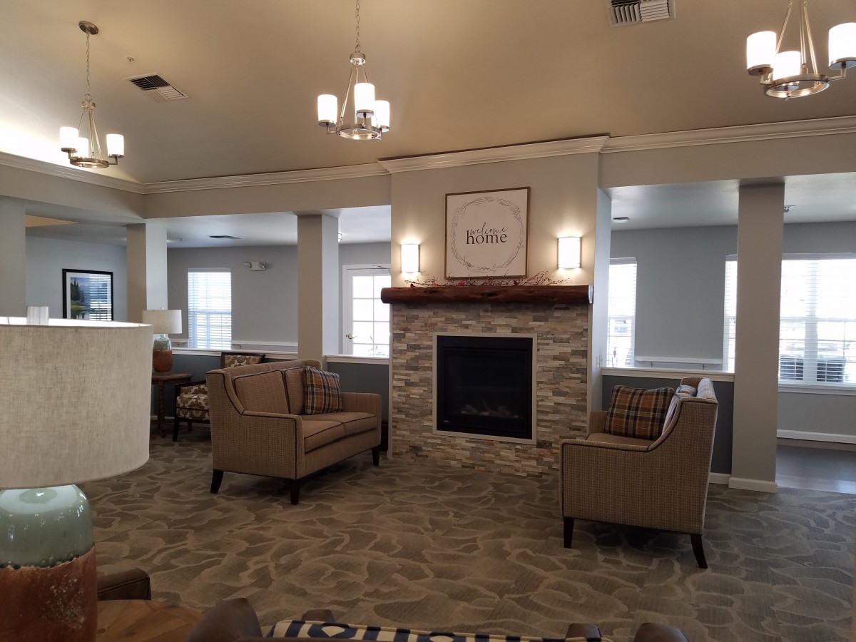 A cozy living room with a fireplace and comfortable seating.