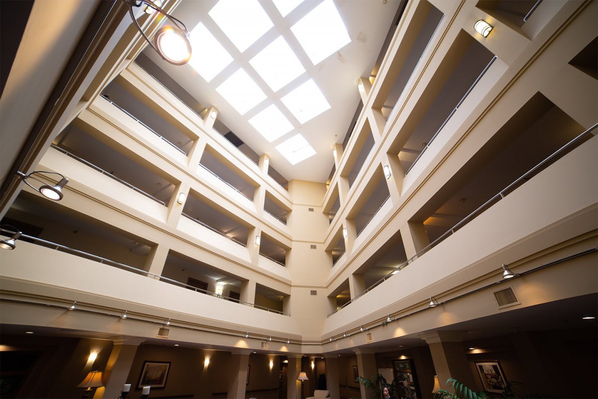 A modern atrium with multiple floors and a large skylight.