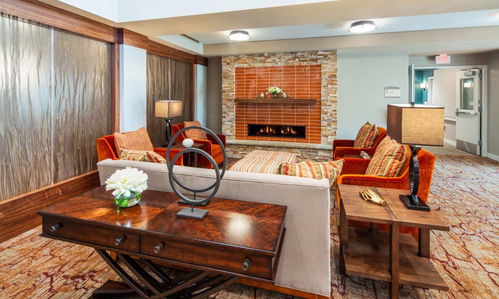 A cozy living room with wooden furniture and a brick fireplace.