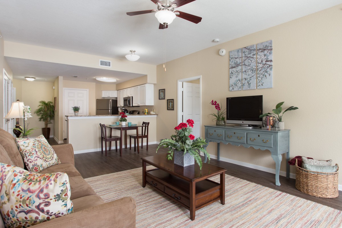 A cozy open-plan living space featuring a comfortable seating area, a dining corner, and a modern kitchen.