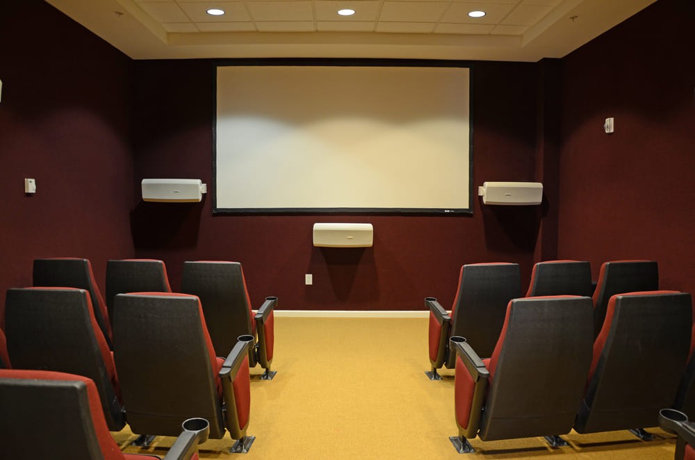 A cozy home theater setup with comfortable seating and a large screen.