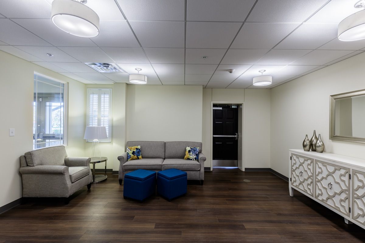 A modern lounge area featuring comfortable seating and contemporary lighting.
