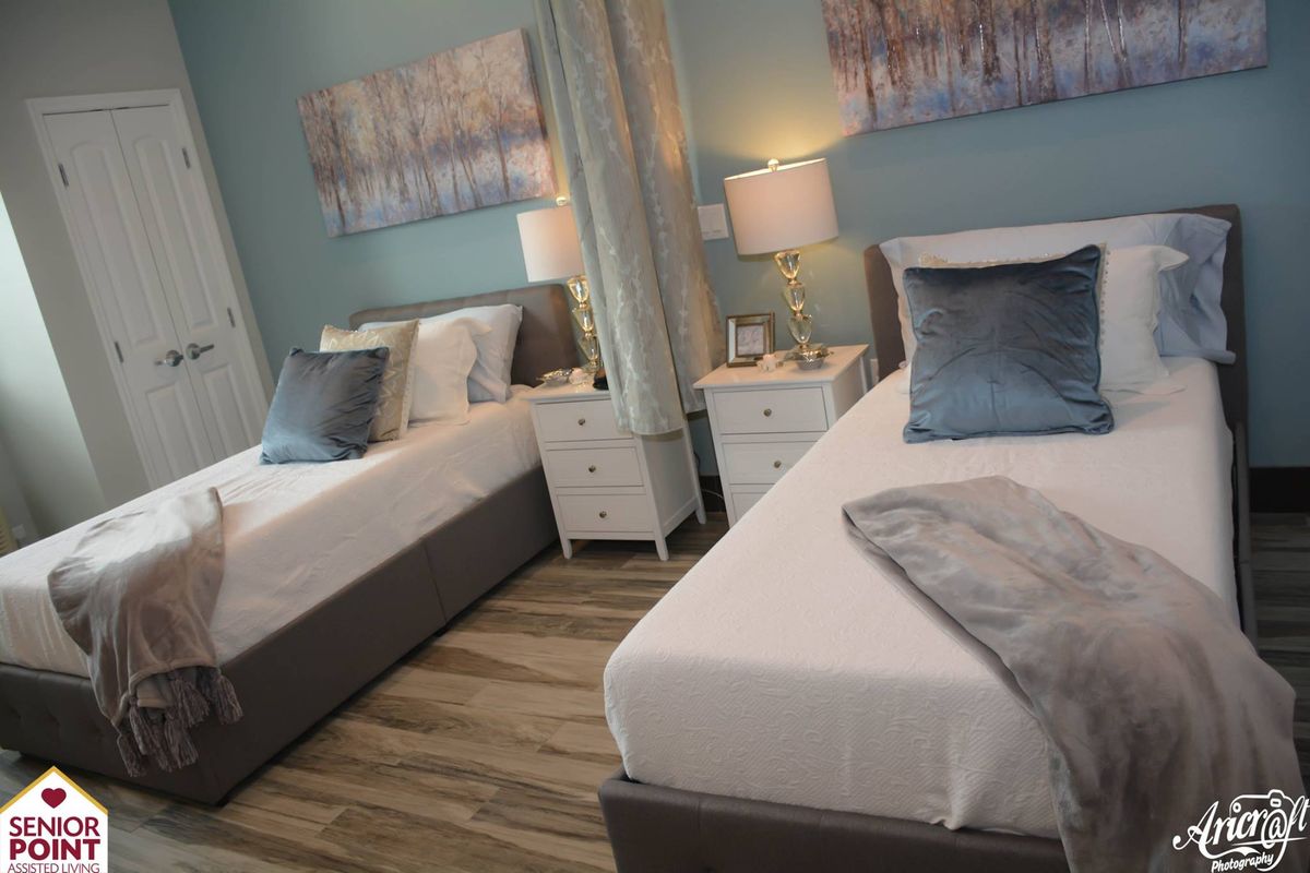 A modern and cozy bedroom featuring twin beds with elegant decor.