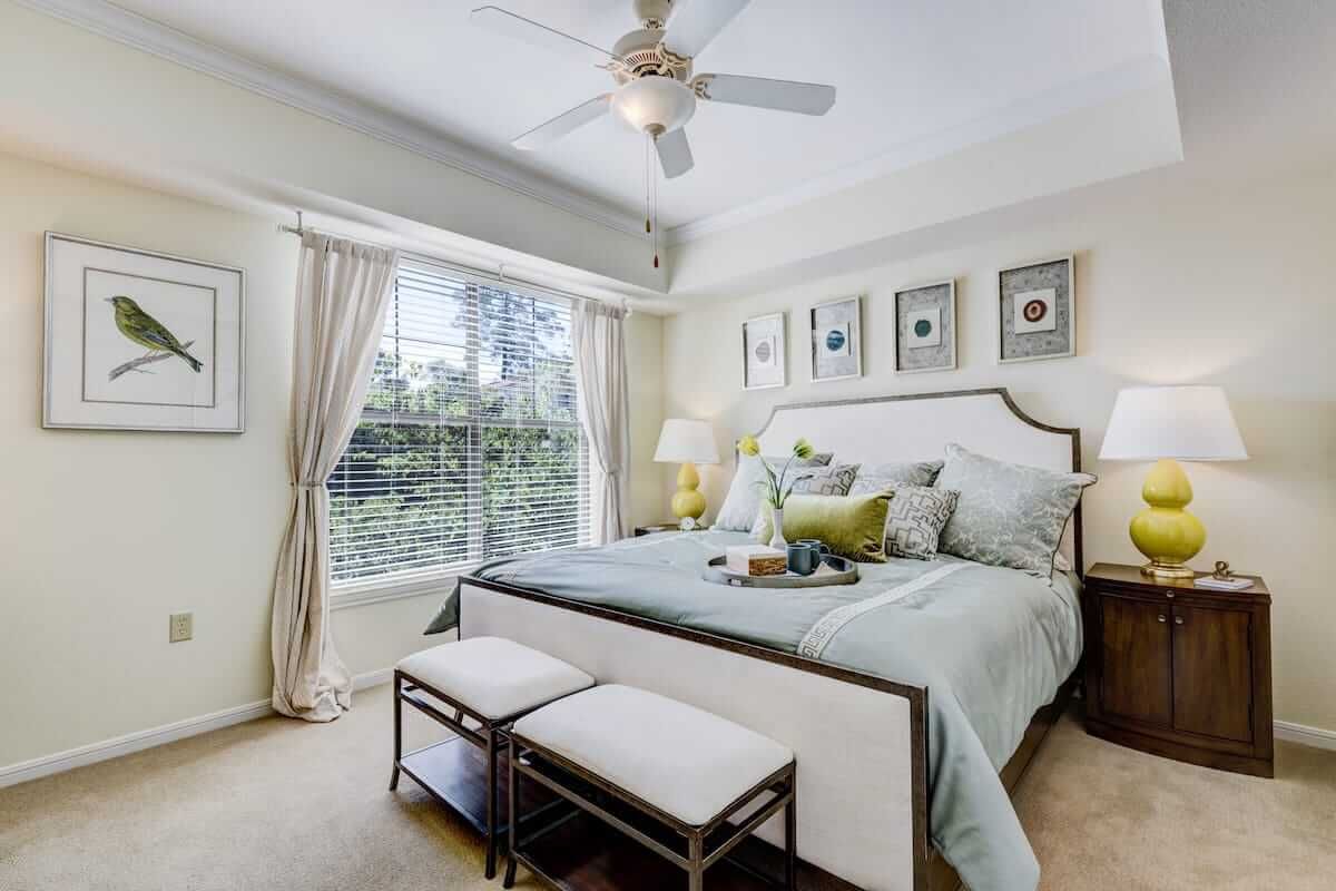 A beautifully decorated bedroom with a large bed, plush pillows, and elegant decor.
