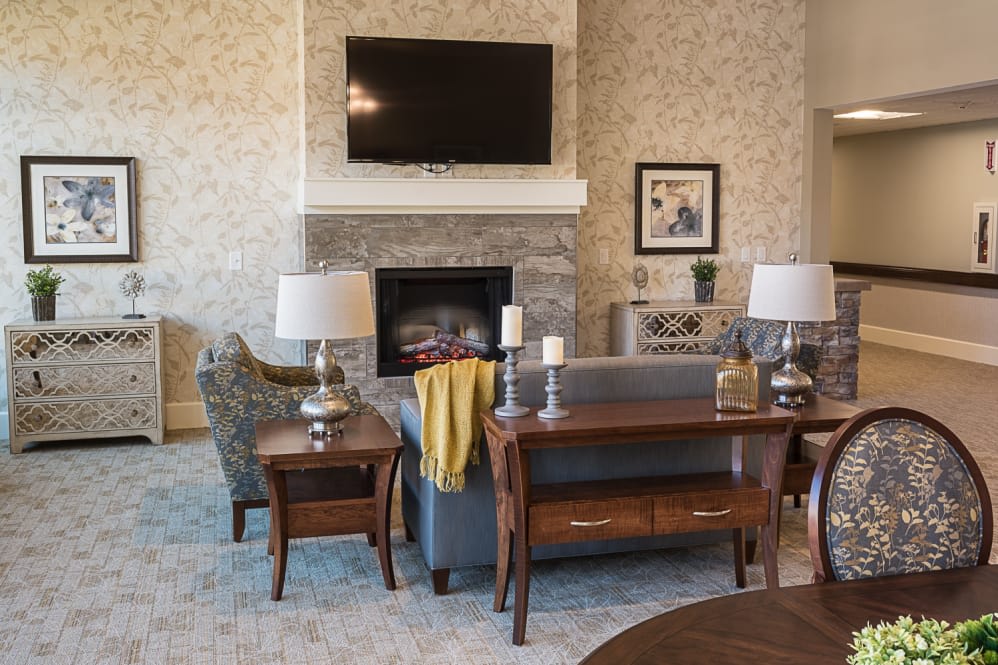 A cozy living room with a fireplace, television, and comfortable seating.