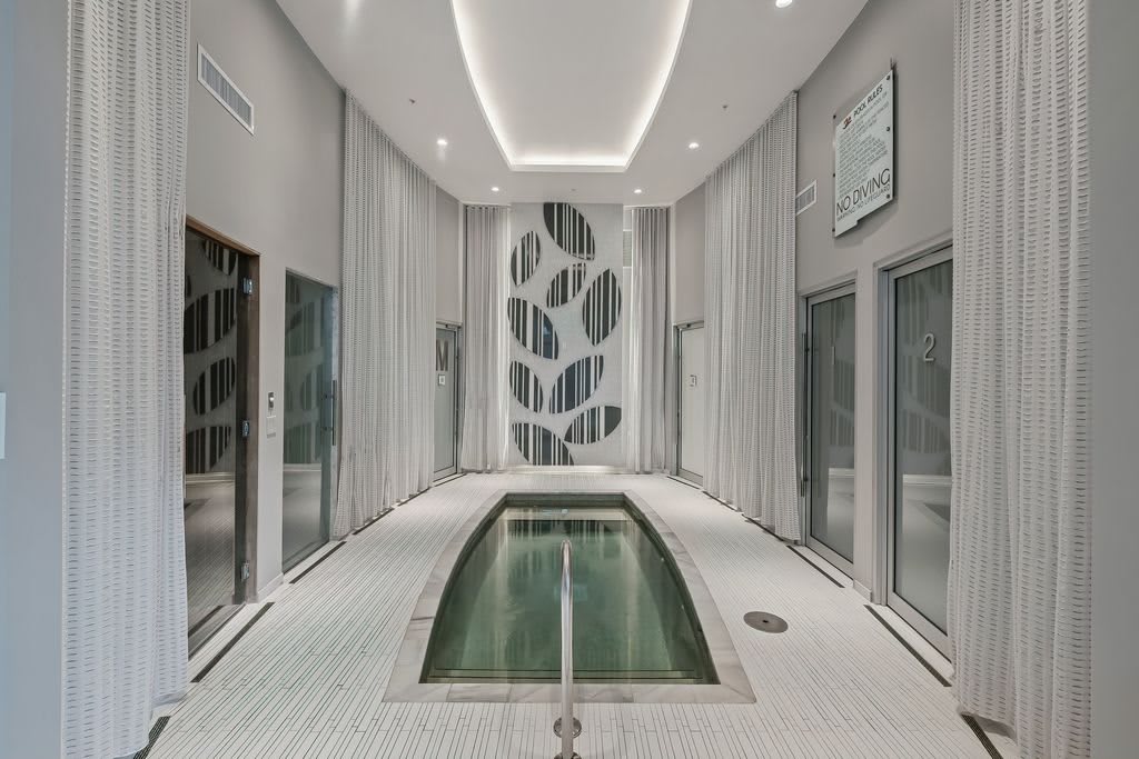 A serene and modern indoor pool area with sleek architectural design.
