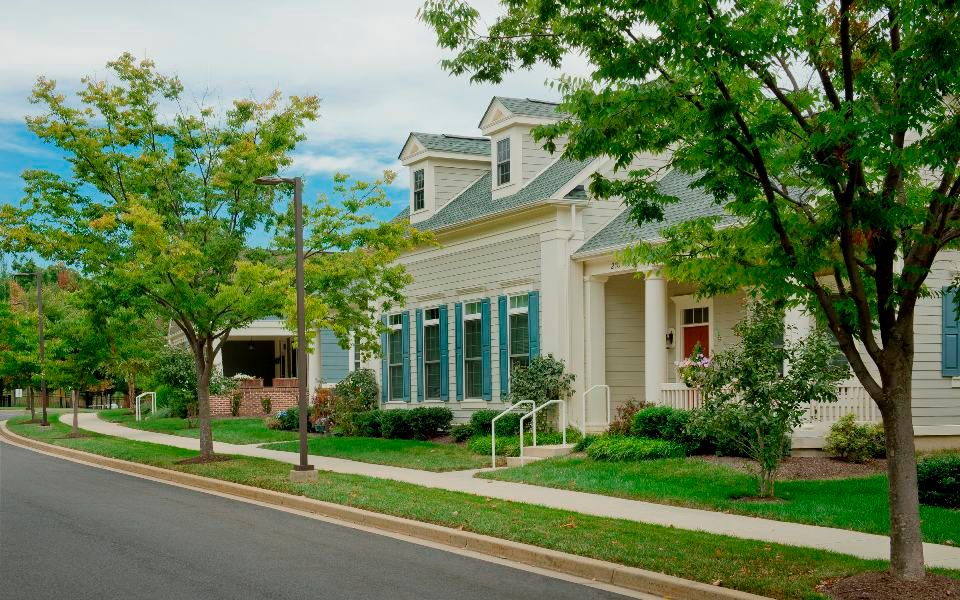 A charming suburban house with a well-maintained lawn and street view.