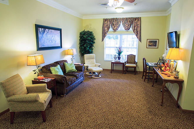 A cozy living room with a comfortable seating arrangement and elegant decor.