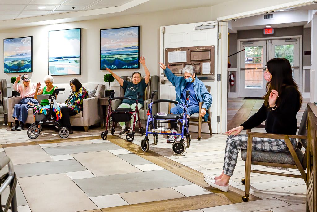 A group of seniors participating in an activity at an assisted living facility.