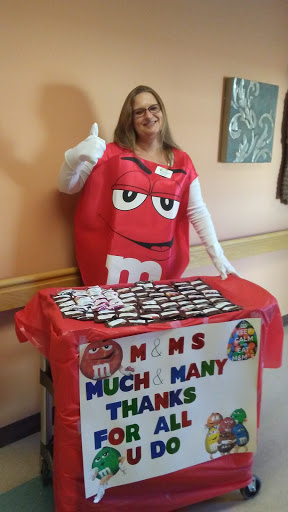 A cheerful individual dressed as an M&M, spreading joy and gratitude at an event.