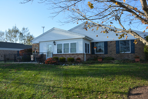 A charming single-story house with a well-maintained front yard.