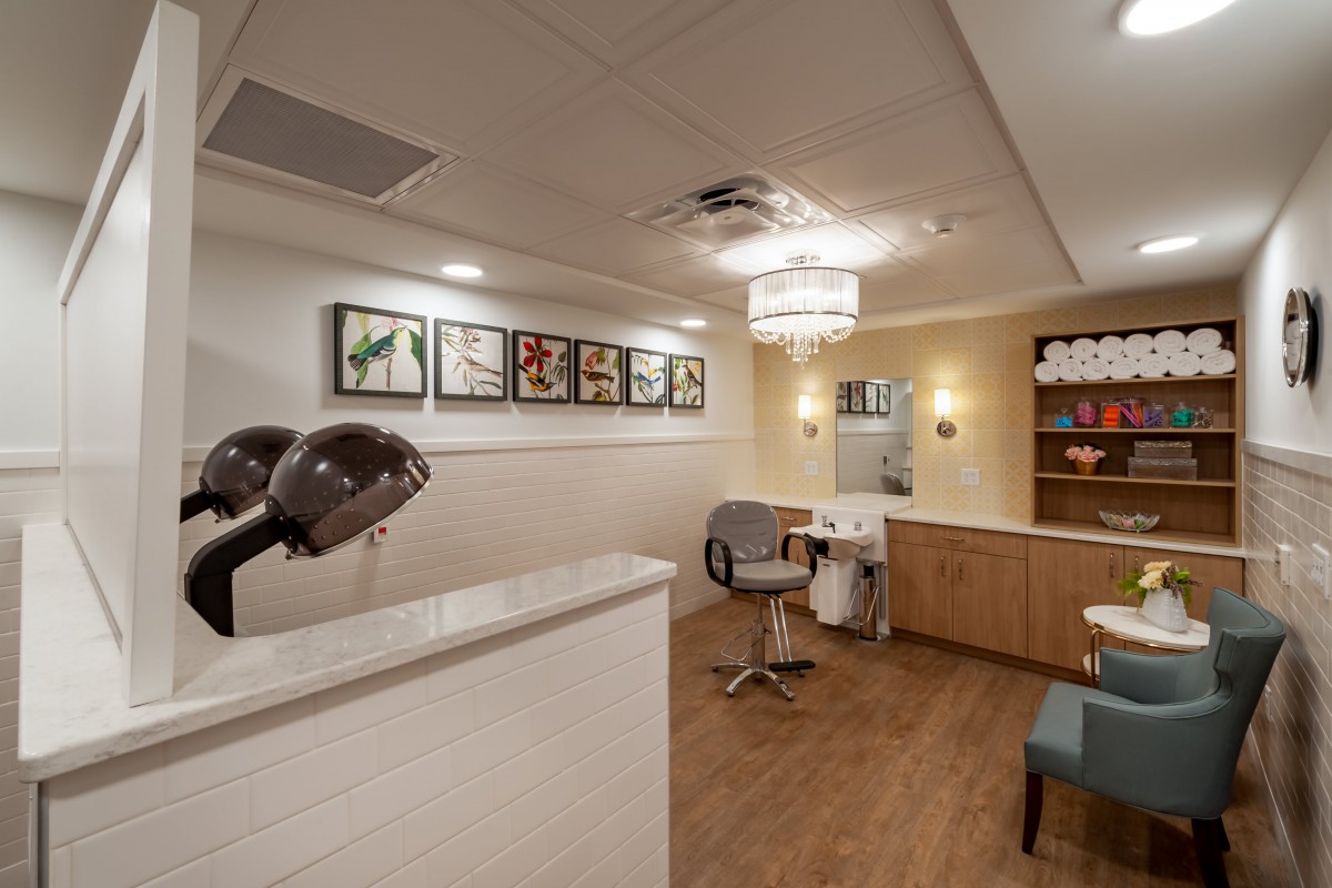 A modern hair salon interior with styling chairs and hair dryers.