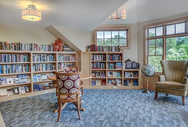 Cozy library room with bookshelves and a comfortable reading chair.