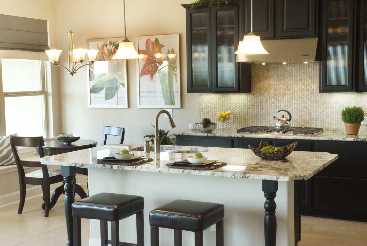 Modern kitchen with stylish countertops, elegant lighting, and comfortable seating.