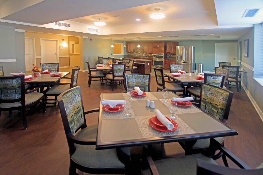 A well-arranged dining room with set tables and chairs, featuring elegant interior design.
