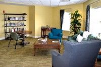 A cozy living room with comfortable furniture and a bookshelf.