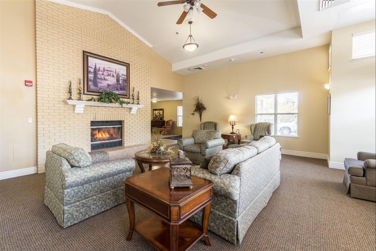 A cozy living room with sofas, a fireplace, and tasteful decor.