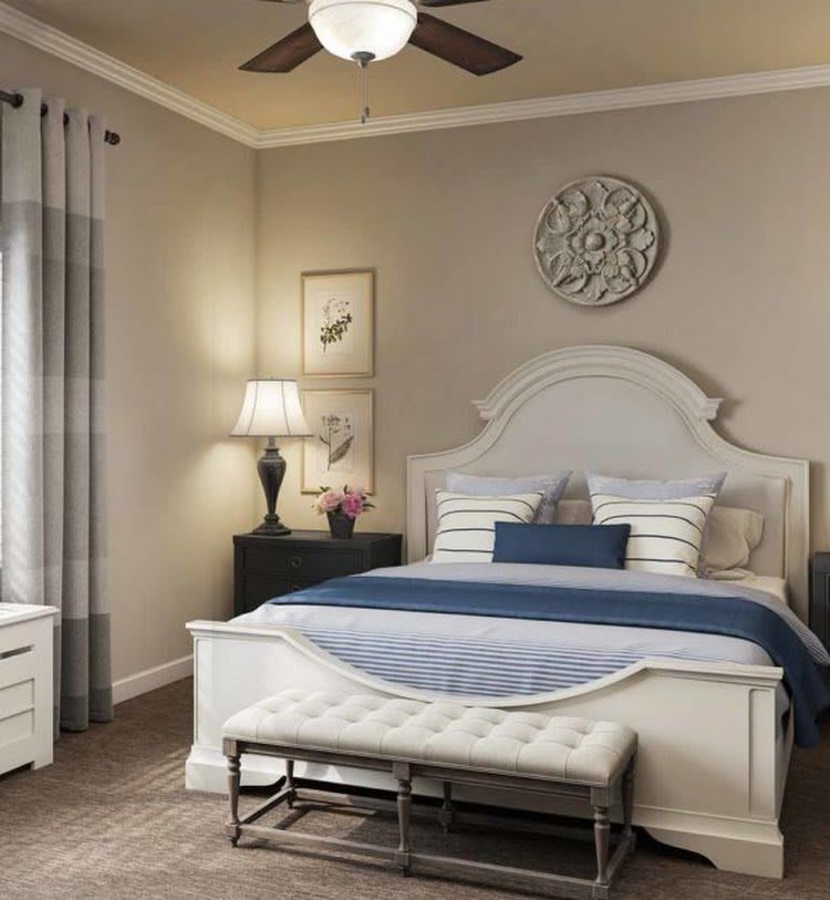 A cozy and elegantly decorated bedroom with neutral tones and stylish furnishings.
