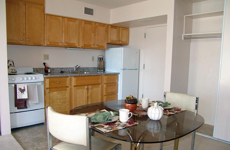 A cozy apartment kitchen with a dining table set for two.
