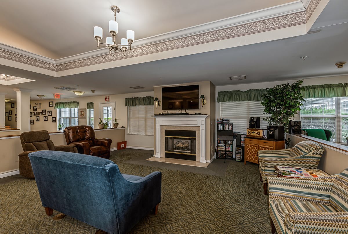A cozy living room with a fireplace and comfortable seating.