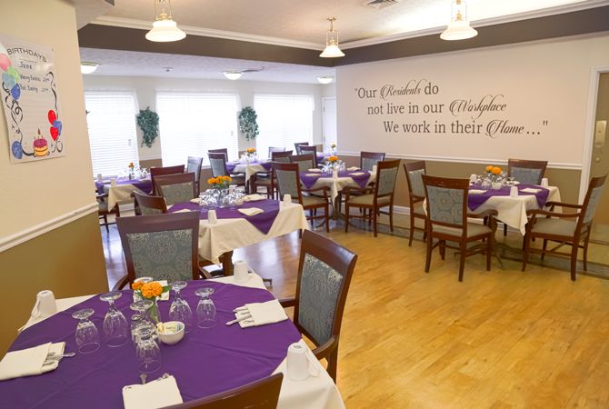 A cozy restaurant dining area with purple tablecloths and neatly arranged tables and chairs.