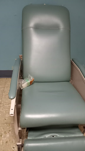 An empty medical chair in a healthcare setting.