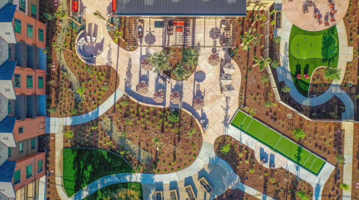 Aerial view of a landscaped garden with winding pathways and outdoor seating areas.