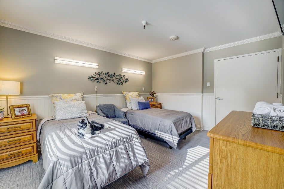 A modern bedroom with twin beds and stylish decor.