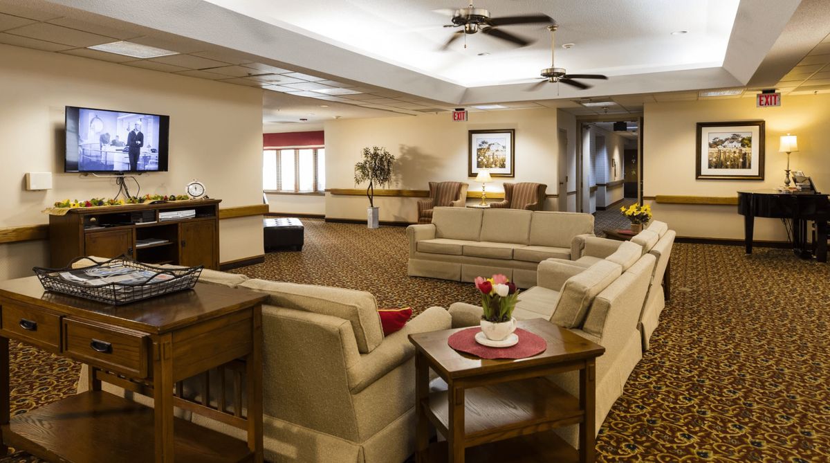 A cozy living room with comfortable sofas and warm lighting.