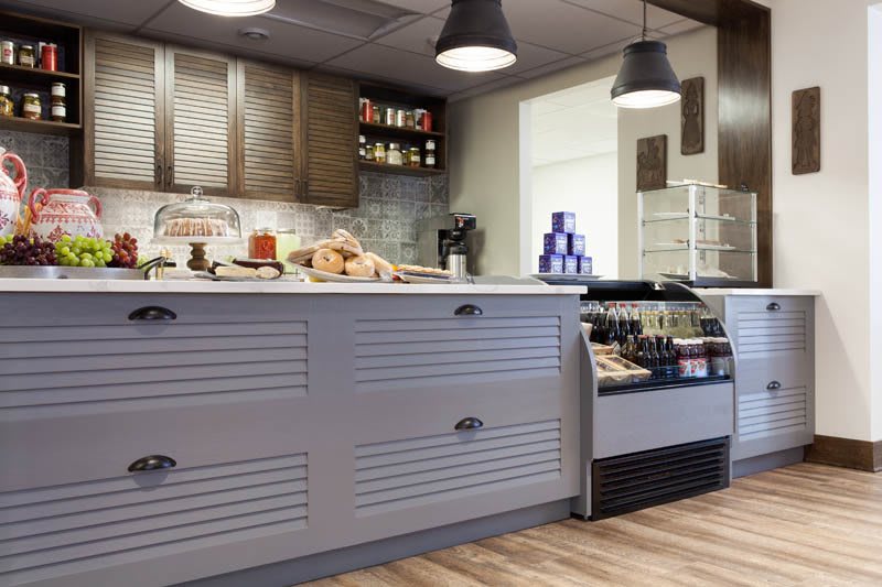 A cozy kitchen interior with a well-equipped countertop and shelves.