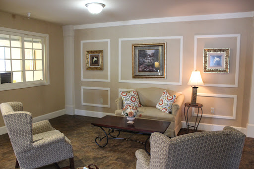 A cozy living room featuring elegant furnishings and decorative artwork.