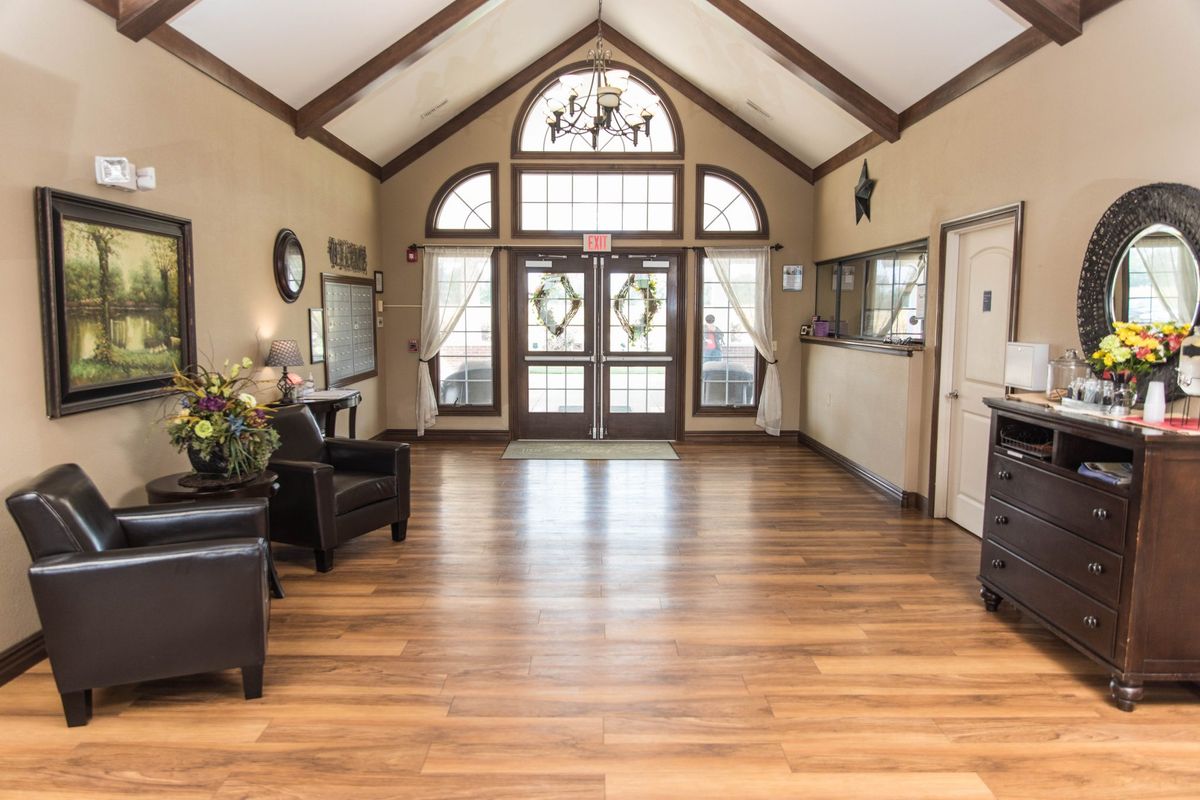 A spacious lobby with wooden flooring and decorative elements.