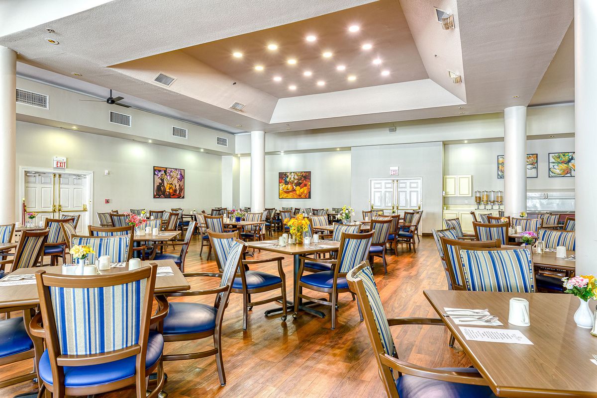Modern restaurant interior with wooden flooring and stylish seating.