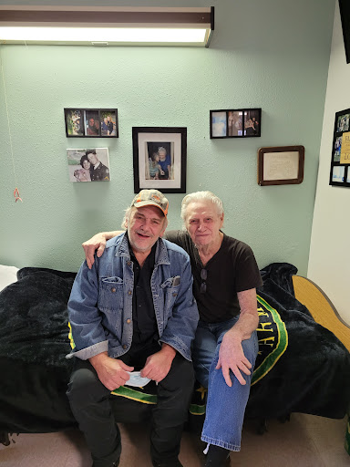 A cheerful moment captured in an indoor setting, showcasing two friends enjoying their time together.