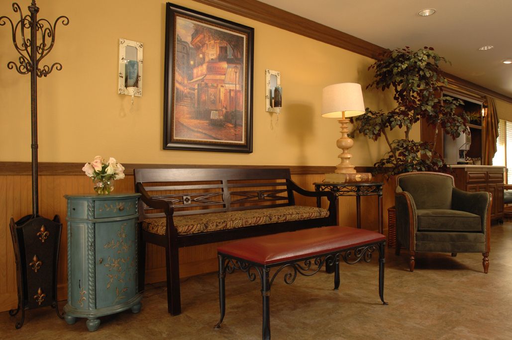 A cozy waiting area with a wooden bench, artwork on the wall, and ambient lighting.