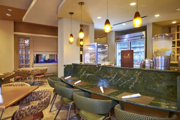 A modern restaurant interior with stylish seating and warm lighting.